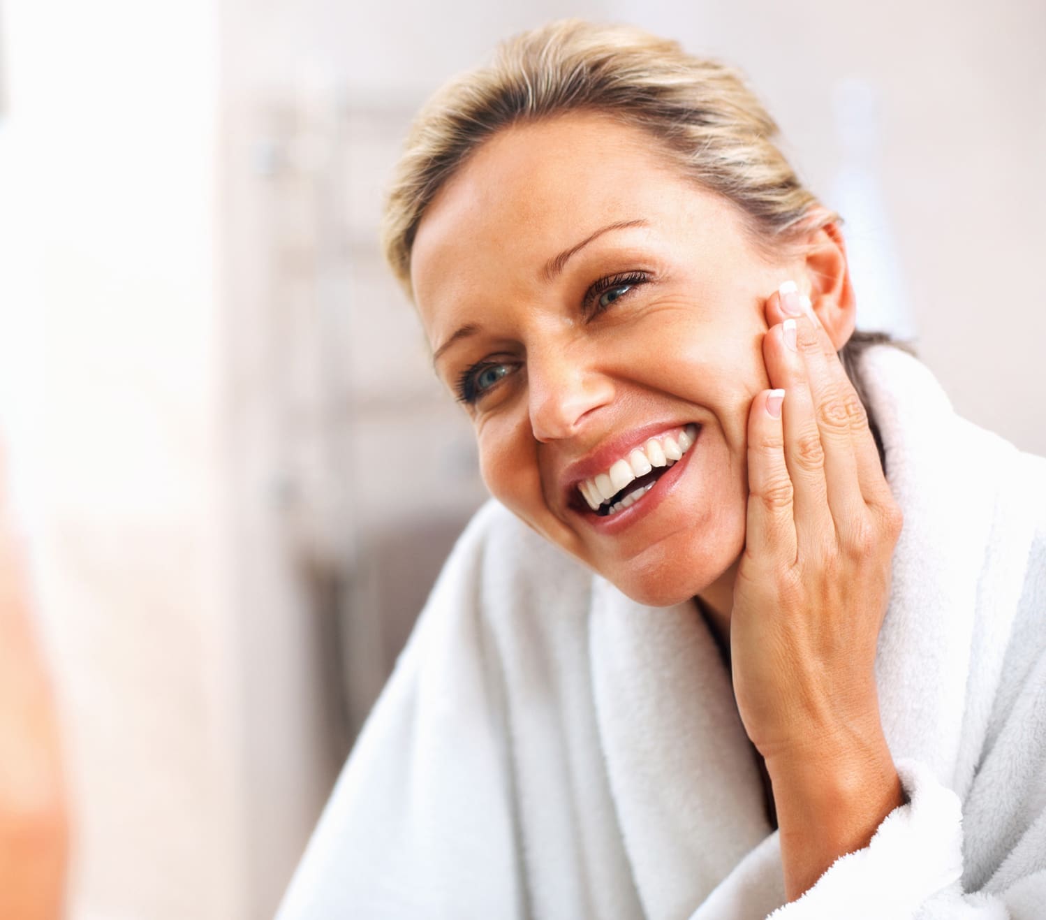 Happy mature woman admiring herself in the mirror Non-Surgical Skin Tightening in Charleston County, SC